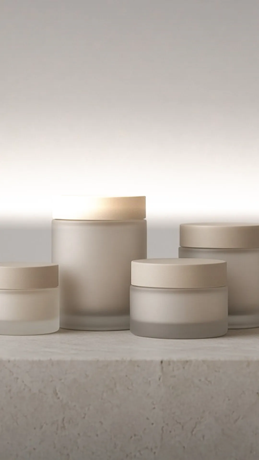 Four unlabeled jars in graduated sizes on a stone plinth